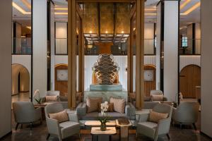 a lobby with a couch and a large vase at Meliá Chiang Mai in Chiang Mai +92 photos