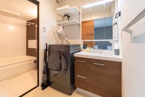 a washer and dryer in a bathroom with a sink at ReLA Minami-Nagareyama in Nagareyama +28 photos