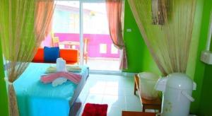 a bedroom with a blue bed and a window at Baan Navy Kohlarn in Ko Larn