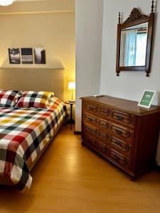 a bedroom with a dresser and a bed and a mirror at Central Home Arouca in Arouca +25 photos