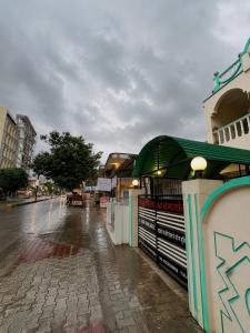 a street with a building on a rainy at Evergreen Bungalows in Dwarka