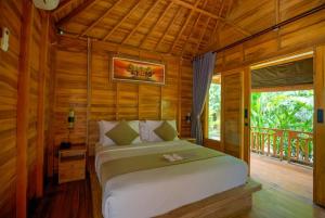 a bedroom with a bed in a wooden room at Angseri Villas in Tabanan +80 photos