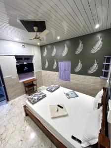 a bedroom with a large white bed in a room at TEMPLE VIEW GUEST HOUSE in Hampi