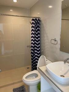 a bathroom with a white toilet and a sink at Jeffrey S Hotel in Boracay +132 photos