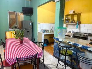 a kitchen with a table with a red and white checkered table cloth at Welcome to the Amazon in Iquitos