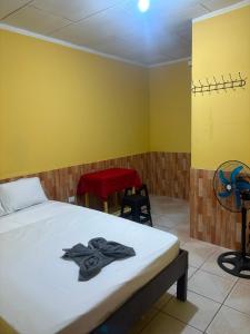 a bedroom with a bed and two chairs in it at Welcome to the Amazon in Iquitos