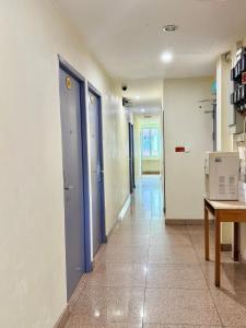a hallway of an office with blue doors and a table at HK Inn Hua Kiew Inn in Miri