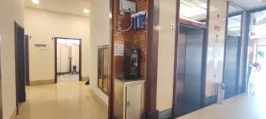 an elevator in a building with a television on the wall at Hotel Ipoh City in Ipoh