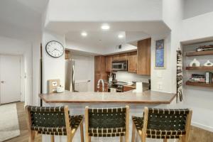 a kitchen with a counter and a clock on the wall at River Pines A303 condo in Edwards