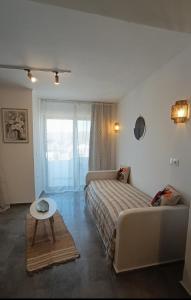 a bedroom with a bed and a table in it at Kanala Sea View in Kanala