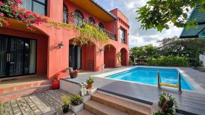 a house with a swimming pool next to a building at พัทลุงเมริเดียนโฮเทล in Phatthalung
