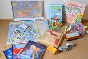 a bunch of toys are sitting on the floor at Villa UMMINA in Tahara