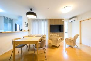 a dining room with a table and chairs at Villa UMMINA in Tahara