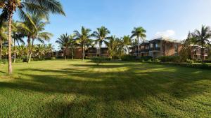 a large yard with palm trees and a building at Meliá Zanzibar in Kiwengwa
