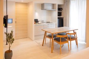 a kitchen and dining room with a table and chairs at ReLA Minami-Nagareyama in Nagareyama
