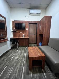 a living room with a couch and a table at Luxmi Hotel in Allahābād +19 photos