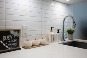 a kitchen counter with a sink and some towels at Filmores Hotel in Toronto +45 photos