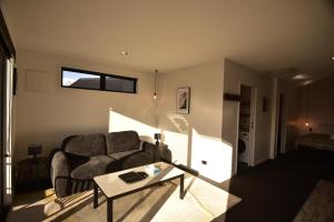a living room with a couch and a table at Simply Stunning Stars A in Lake Tekapo