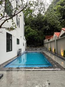 a swimming pool in front of a building at Trang An Heritage Hotel in Nguyên Ngoại