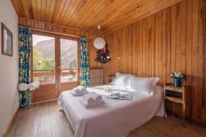 a bedroom with a bed with towels on it at MontBlanc Alpine Ski & Sauna Retreat - Happy Rentals in Le Tour +25 photos