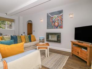 a living room with a couch and a television at High Spy in Keswick