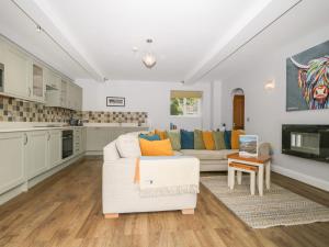 a living room with a couch and a kitchen at High Spy in Keswick