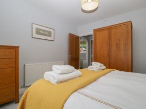 a bedroom with a bed with towels on it at High Spy in Keswick