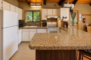 a kitchen with white appliances and a counter top at Icicle Chalet in Leavenworth