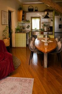 a living room with a table and a kitchen at Apartment Baci in Rose resort in Ljubljana +28 photos