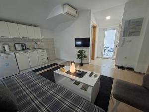 a living room with a bed and a kitchen at Apartments Platz in Mostar