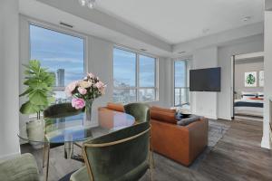 a living room with a glass table and a couch at Filmores Hotel in Toronto