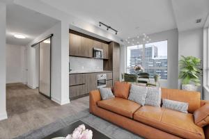 a living room with a couch and a kitchen at Filmores Hotel in Toronto