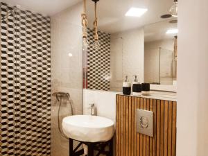 a bathroom with a white sink and a mirror at Gryfon Dom in Jastarnia