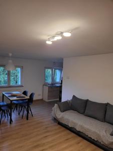 a living room with a couch and a table at Bobrowe zacisze in Wleń