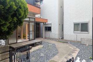 a wooden bench sitting in front of a building at ぷにるんパーク in Nagoya