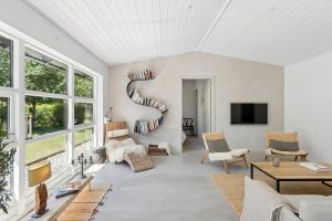 a living room with a spiral bookshelf at Luxury Retreat Surrounded By Nature in Rønde