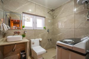a bathroom with a white toilet and a sink at Blume House- 4BHK Holiday Home with Kitchen & Garden in Srinagar +47 photos