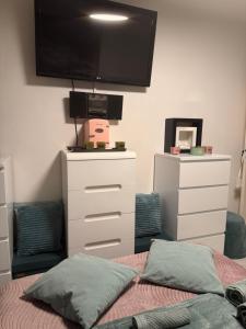 a bedroom with a bed and a flat screen tv at CHAMBRE dans appartement moderne guest house in Menton