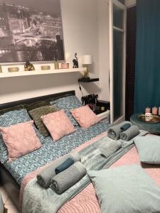 a bedroom with a bed with pillows on it at CHAMBRE dans appartement moderne guest house in Menton