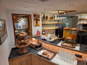 a kitchen with a counter with glasses on it at Hotel Panorama in Elbigenalp