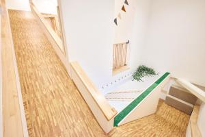 a staircase in a house with a green floor at ぷにるんパーク in Nagoya +49 photos