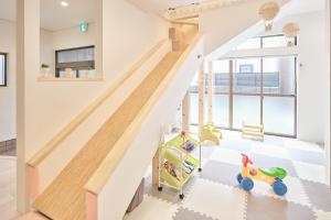 a childs room with a staircase with a toy car at ぷにるんパーク in Nagoya