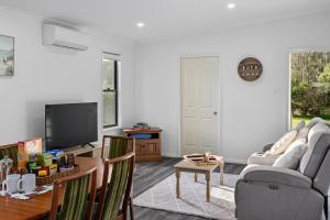 a living room with a couch and a tv at Native Retreat - Tranquil Seaham Escape in Seaham