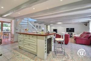 a kitchen and living room with a table and chairs at Ty venoux in Elven