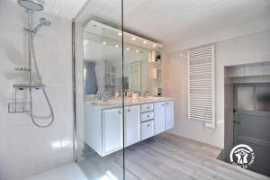 a white bathroom with a shower and a sink at Ty venoux in Elven +34 photos