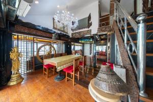 a dining room with a table and chairs and a chandelier at Crystal Sea Villa in Ko Larn