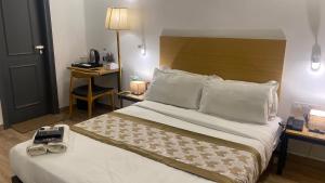 a hotel room with a bed and a desk at Saltstayz Express - Golf Course Road & DLF Phase-1 in Gurgaon +45 photos