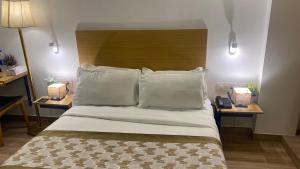 a bedroom with a large bed with two night stands at Saltstayz Express - Golf Course Road & DLF Phase-1 in Gurgaon