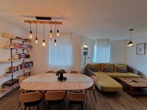 a living room with a table and a couch at COM Home Sovata in Sovata