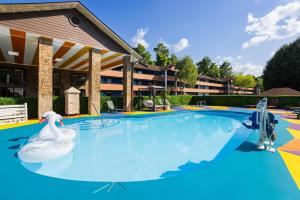 a swimming pool at a resort with a swan in it at Days Inn By Wyndham Pigeon Forge South in Pigeon Forge